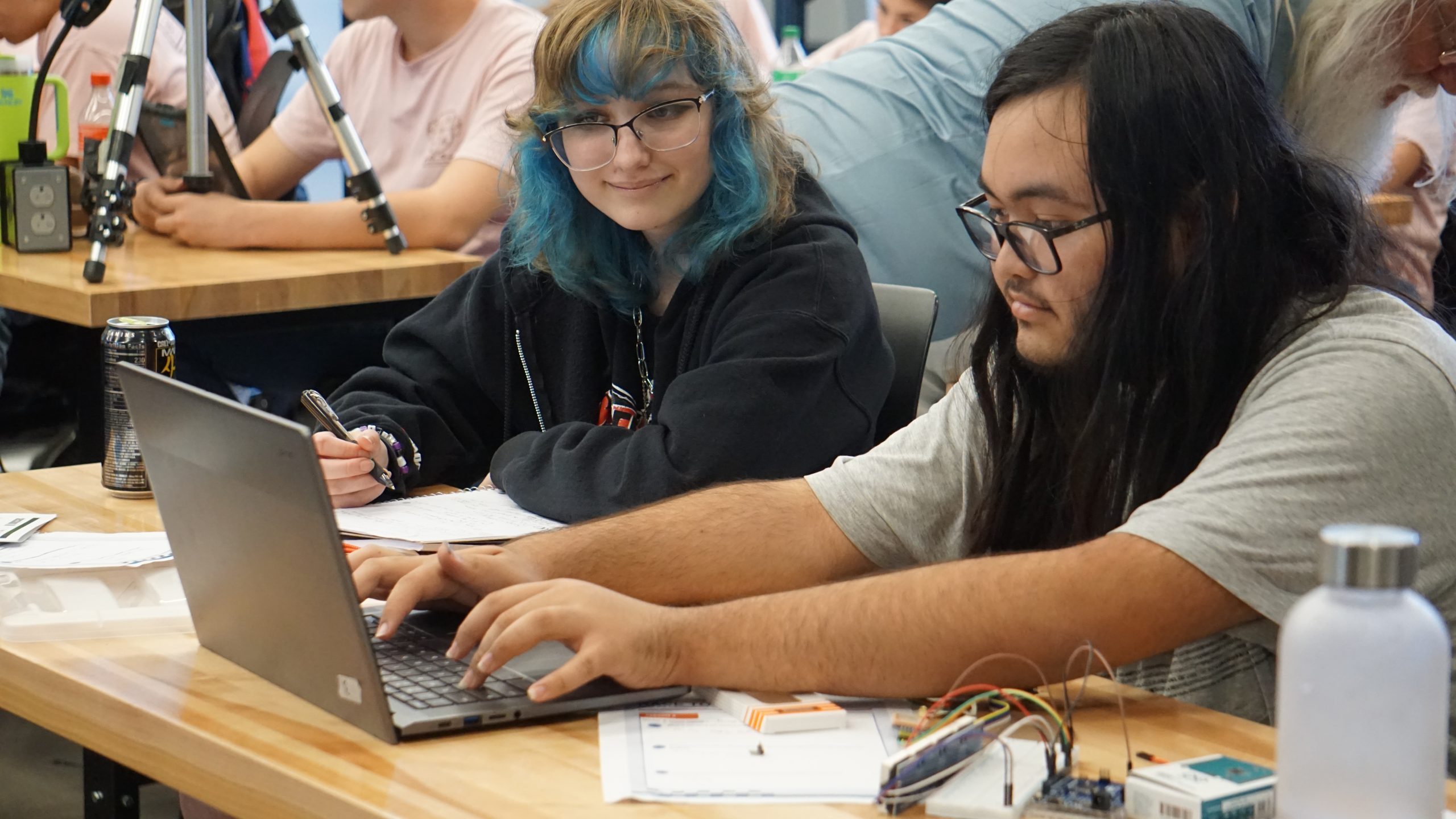 Two teens work together on coding an Arduino speedometer for Racing the Sun.